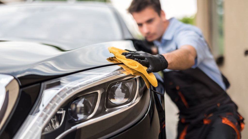 A man cleaning the exterior of the car