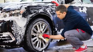 Worker Washing Car